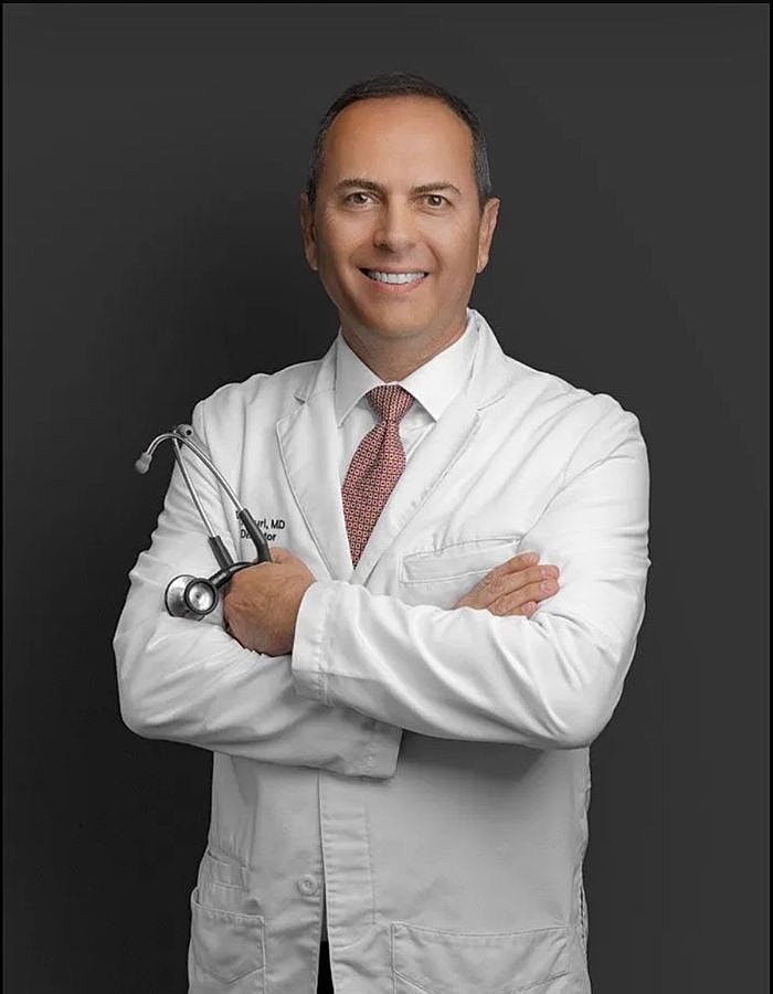 Smiling doctor in white coat with stethoscope.