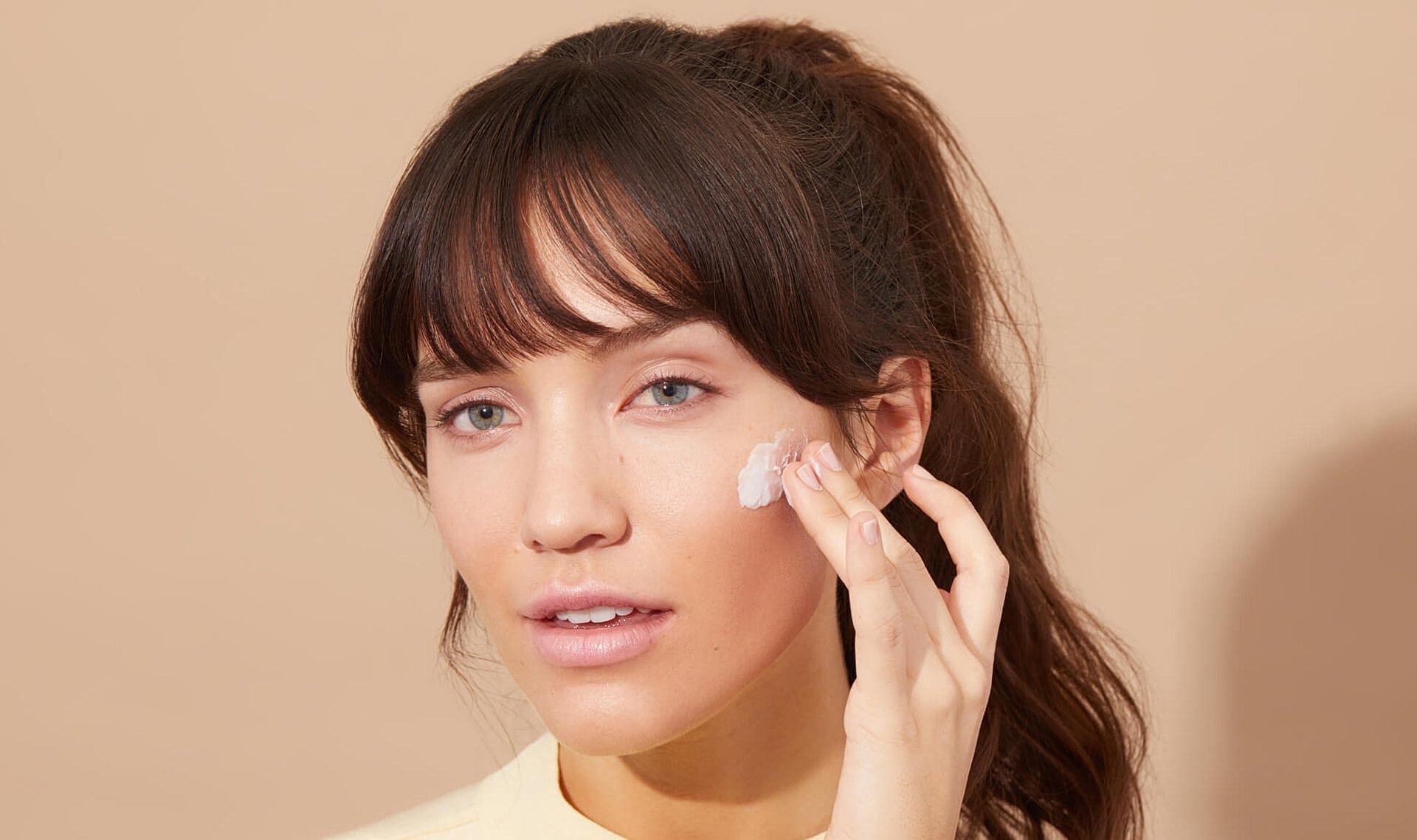 Smiling man in casual attire with a beard.